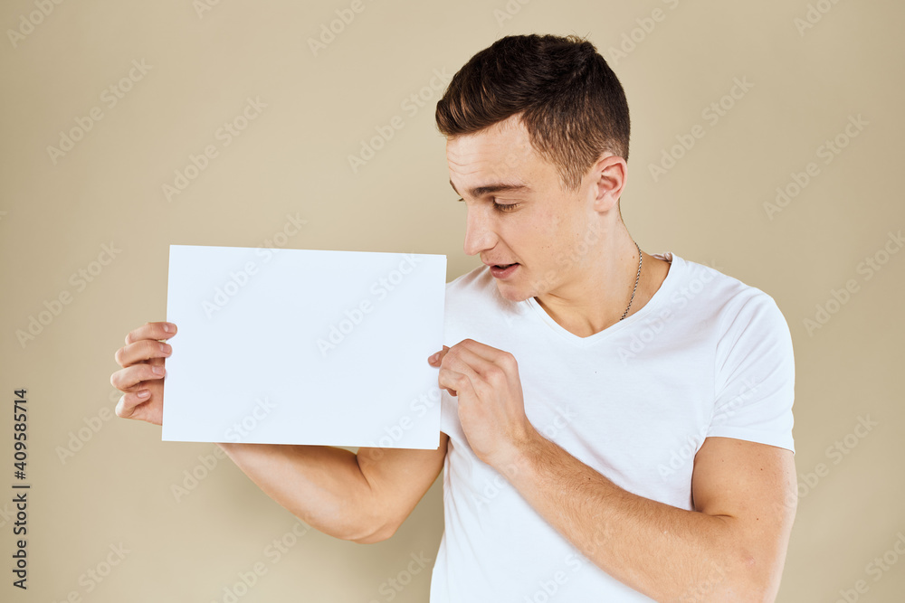man in white t-shirt sheet of paper in hands Copy Space cropped view beige background man in white t-shirt sheet of paper in hands Copy Space cropped view beige background