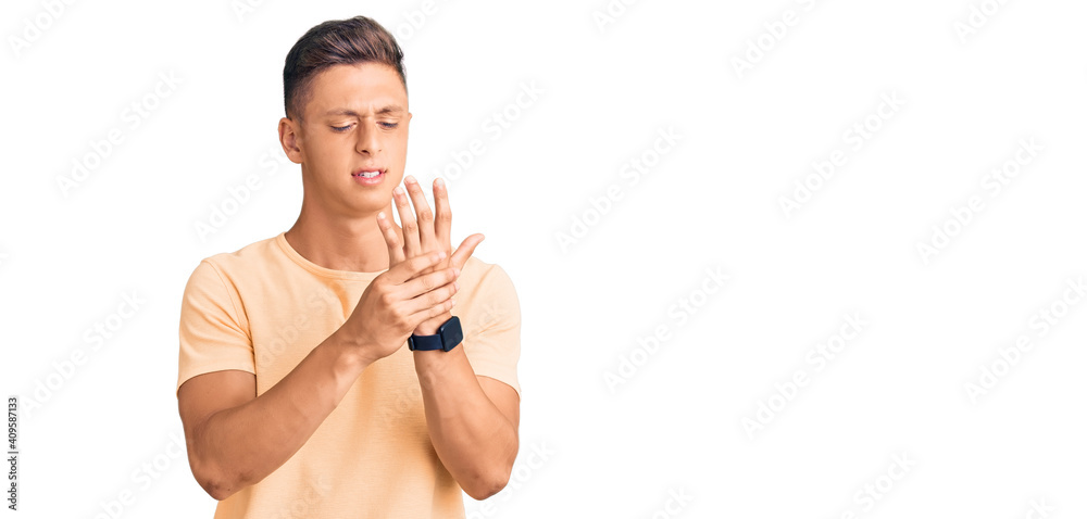 Fototapeta premium Young handsome man wearing casual clothes suffering pain on hands and fingers, arthritis inflammation