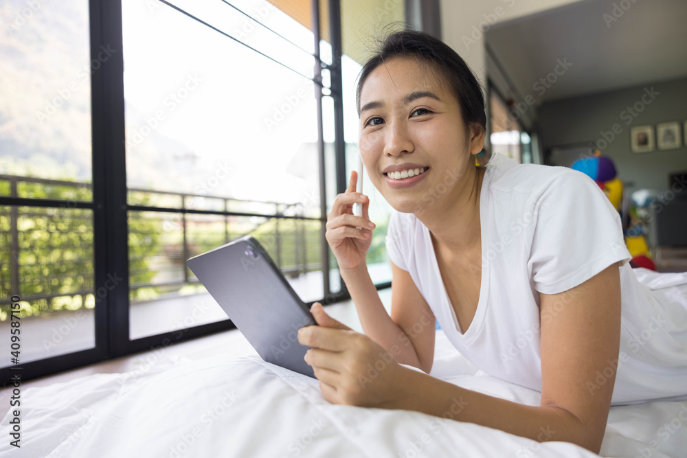 woman using digital tablet in a bed at home. The use of concept of new generation, family, parenthood, authenticity, connection, technology. woman using digital tablet in a bed at home. The use of concept of new generation, family, parenthood, authenticity, connection, technology.