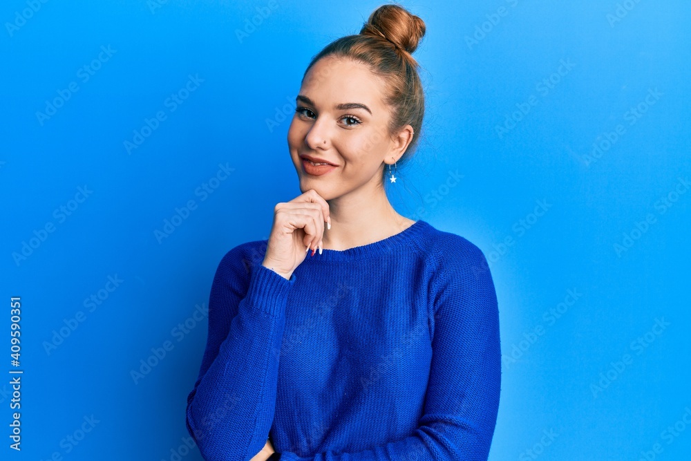 Young blonde woman wearing casual clothes smiling looking confident at the camera with crossed arms and hand on chin. thinking positive. Young blonde woman wearing casual clothes smiling looking confident at the camera with crossed arms and hand on chin. thinking positive.