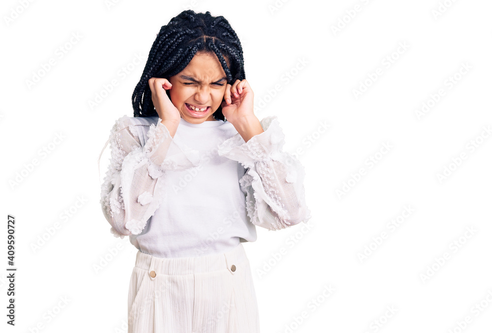 Cute african american girl wearing casual white tshirt covering ears with fingers with annoyed expression for the noise of loud music. deaf concept.