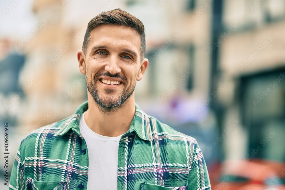 Young caucasian man smiling happy standing at the city. Young caucasian man smiling happy standing at the city.