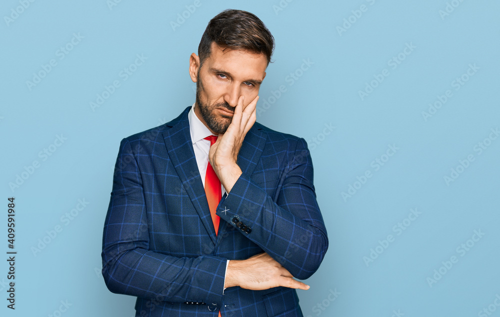 Handsome man with beard wearing business suit and tie thinking looking tired and bored with depression problems with crossed arms. Handsome man with beard wearing business suit and tie thinking looking tired and bored with depression problems with crossed arms.