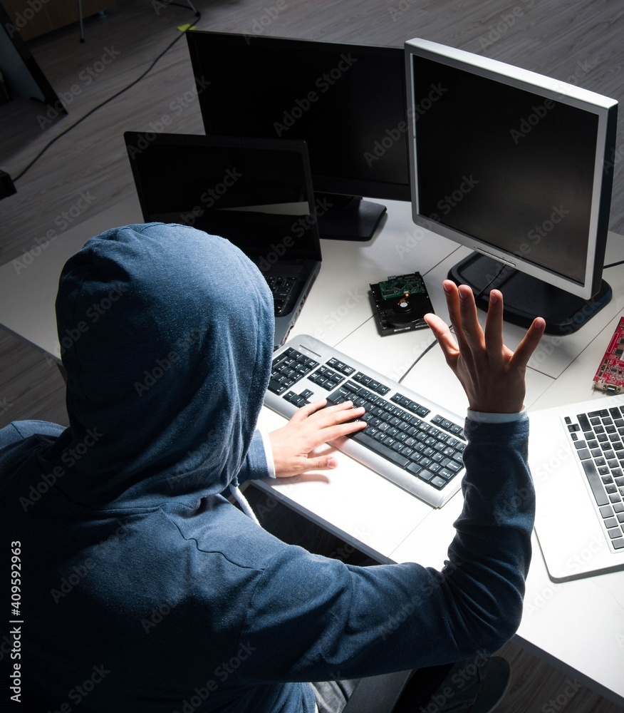 Hacker hacking computer at night