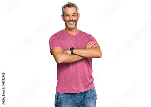 Middle age grey-haired man wearing casual clothes happy face smiling with crossed arms looking at the camera. positive person. © Krakenimages.com