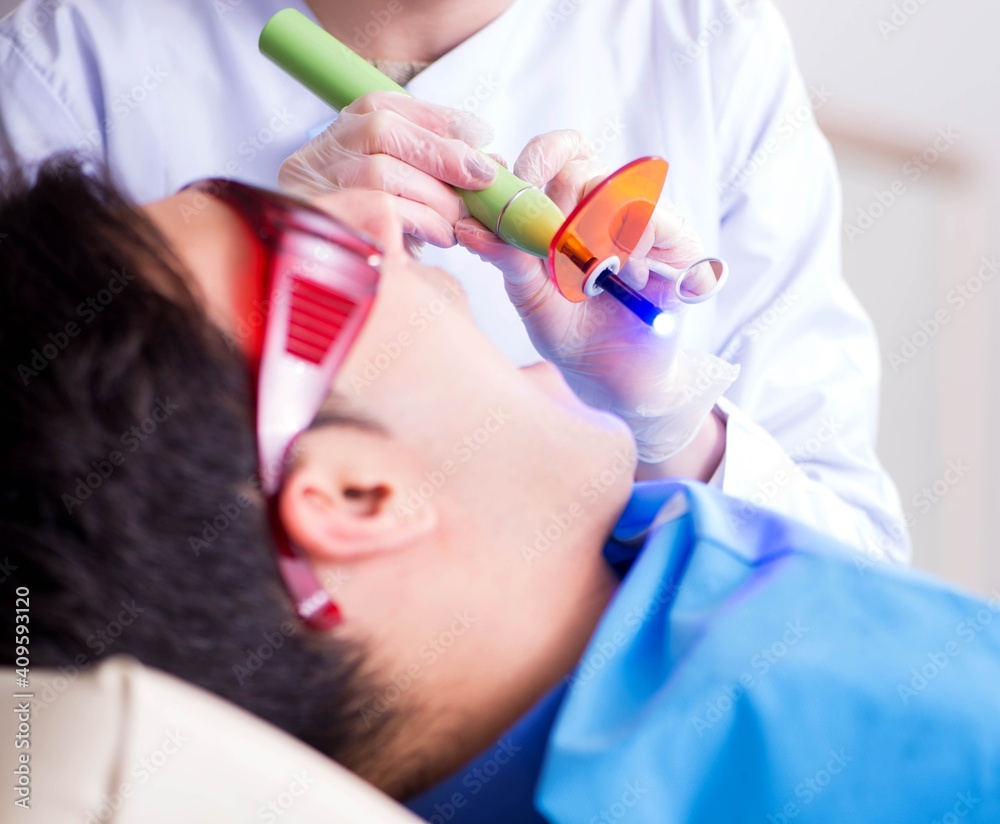Naklejka premium Patient visiting dentist for regular check-up and filling