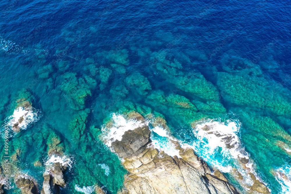 Aerial drone top view of beautiful sea waves and fantastic rocky coast. The concept of calmness, silence and unity with nature