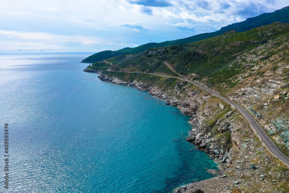 Aerial view of the famous D80 road around Cap Corse peninsula, the important tourist path in Corsica Island, Haute-Corse, France. Tourism and vacations concept