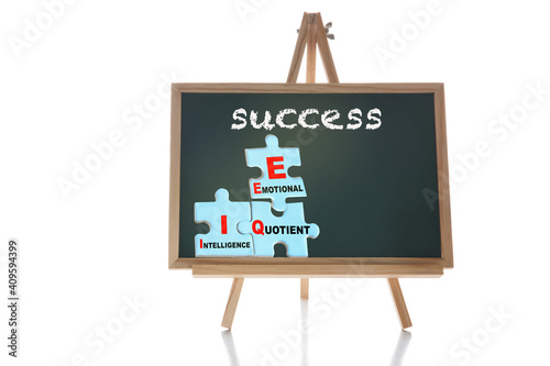 EQ and IQ formula for success concept and leadership idea. Success written on chalkboard with emotional and intelligence quotient on puzzle on white background
