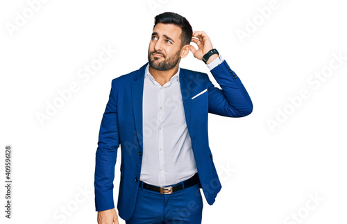 Young hispanic man wearing business jacket confuse and wondering about question. uncertain with doubt, thinking with hand on head. pensive concept.