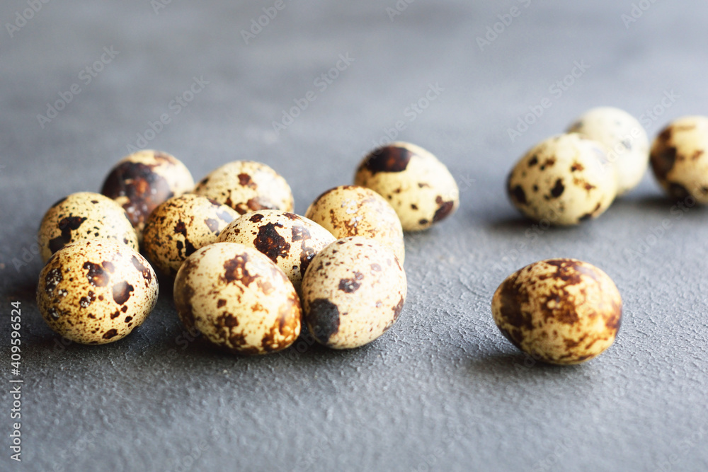 Group of quail eggs on the black background. Textured background with small quail eggs. Eco products. Horizontal format Group of quail eggs on the black background. Textured background with small quail eggs. Eco products. Horizontal format
