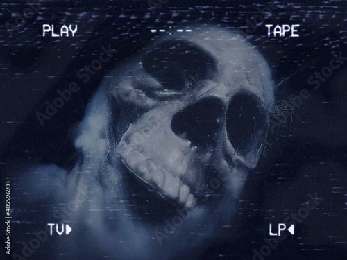 An old damaged VHS tape showing a spooky human skull, covered with spider webs and other nasty stuff. Blueish colors.

