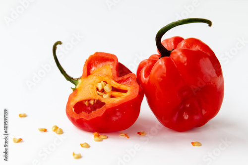 Photos red habanero chilli peppers in whole and half cut with seeds around