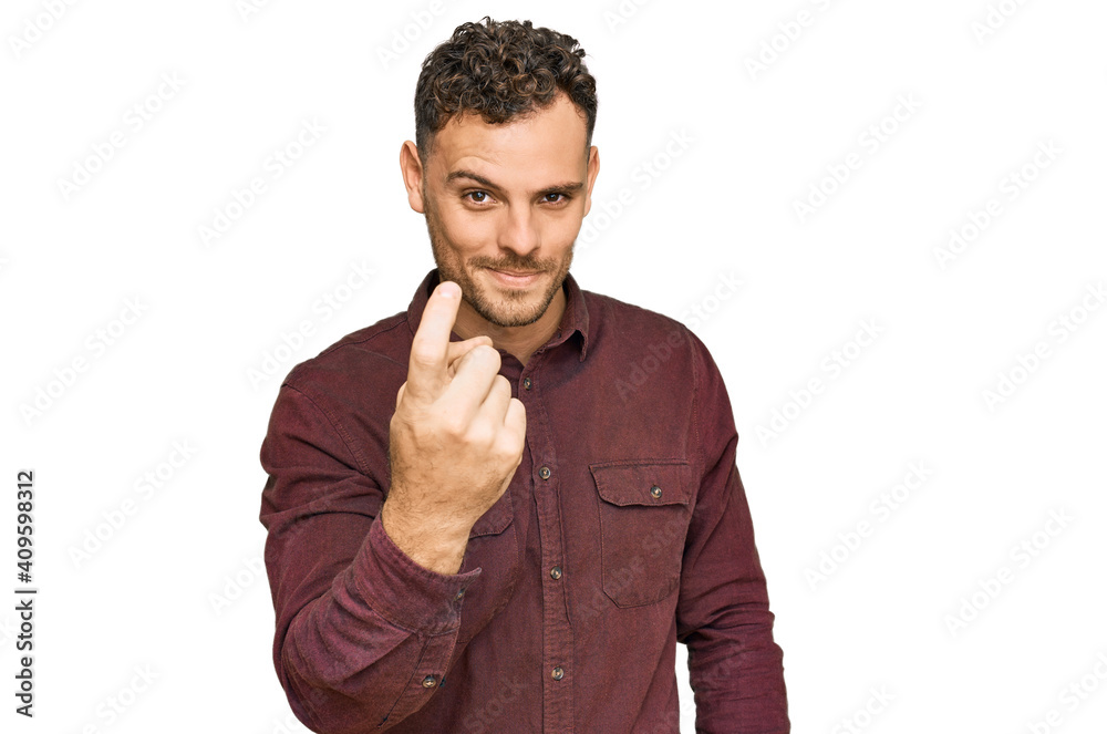 Young hispanic man wearing casual clothes beckoning come here gesture with hand inviting welcoming happy and smiling Young hispanic man wearing casual clothes beckoning come here gesture with hand inviting welcoming happy and smiling