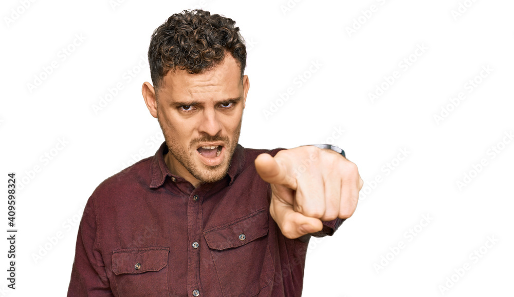 Young hispanic man wearing casual clothes pointing displeased and frustrated to the camera, angry and furious with you Young hispanic man wearing casual clothes pointing displeased and frustrated to the camera, angry and furious with you