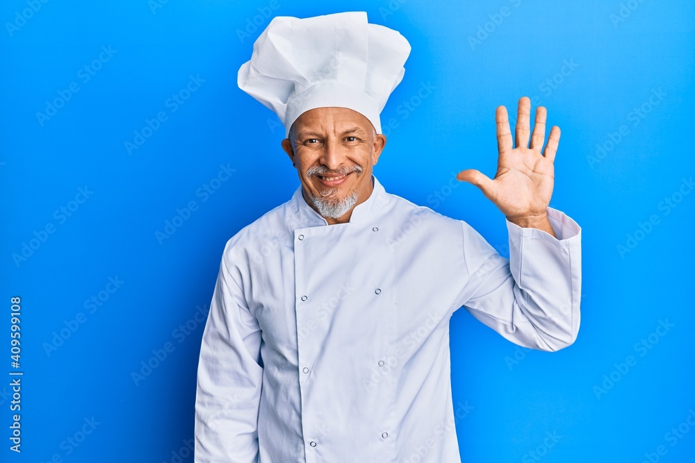 Middle age grey-haired man wearing professional cook uniform and hat showing and pointing up with fingers number five while smiling confident and happy. Middle age grey-haired man wearing professional cook uniform and hat showing and pointing up with fingers number five while smiling confident and happy.