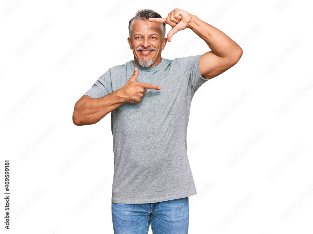 Middle age grey-haired man wearing casual clothes smiling making frame with hands and fingers with happy face. creativity and photography concept. Middle age grey-haired man wearing casual clothes smiling making frame with hands and fingers with happy face. creativity and photography concept.