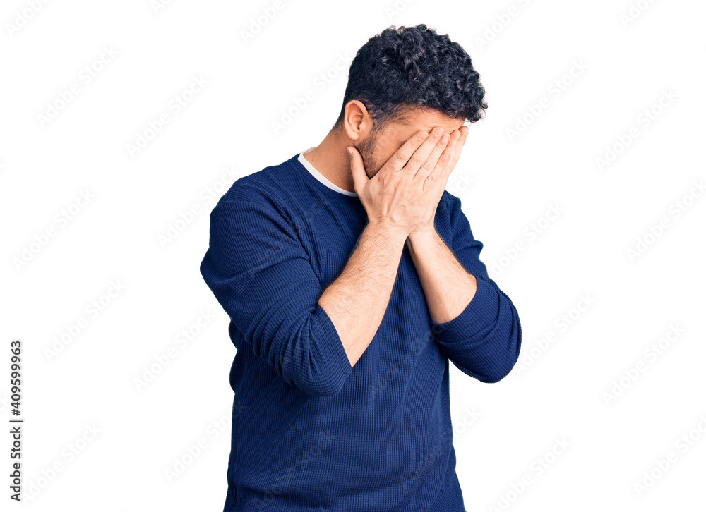 Young hispanic man wearing casual clothes with sad expression covering face with hands while crying. depression concept. Young hispanic man wearing casual clothes with sad expression covering face with hands while crying. depression concept.
