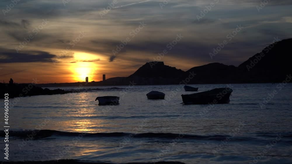 beautiful sunset on the beach with boats and very colorful on the beach of Alicante, Spain beautiful sunset on the beach with boats and very colorful on the beach of Alicante, Spain