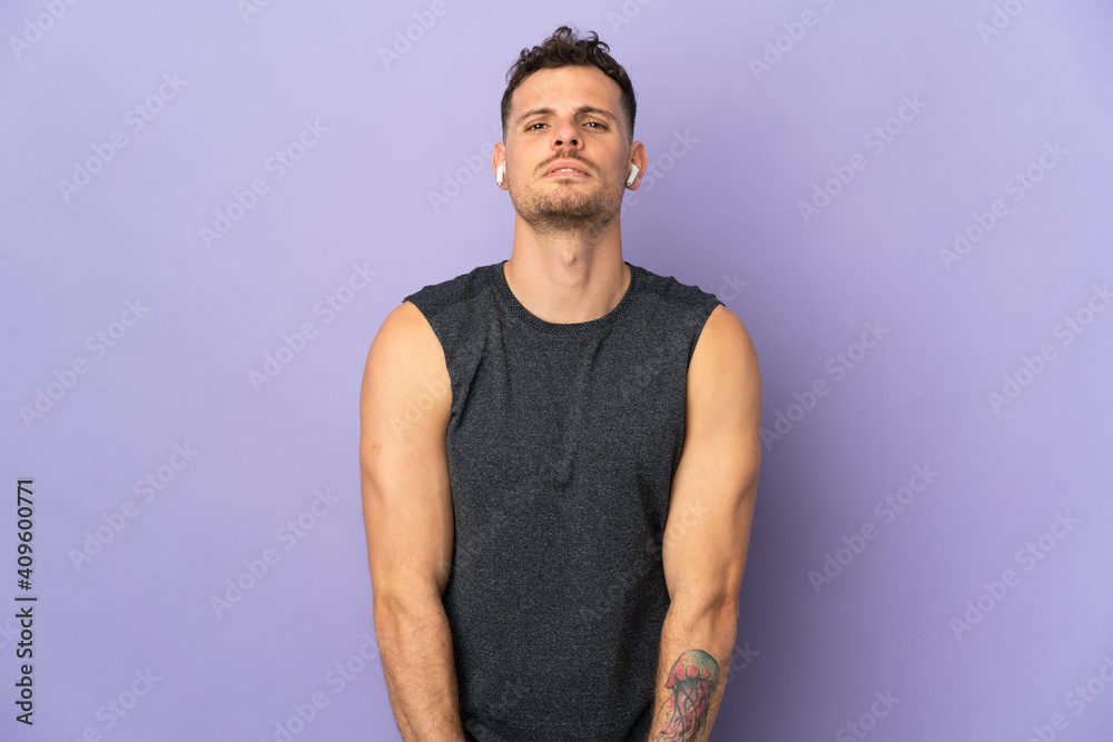 Young caucasian handsome man isolated on purple background stretching arm Young caucasian handsome man isolated on purple background stretching arm