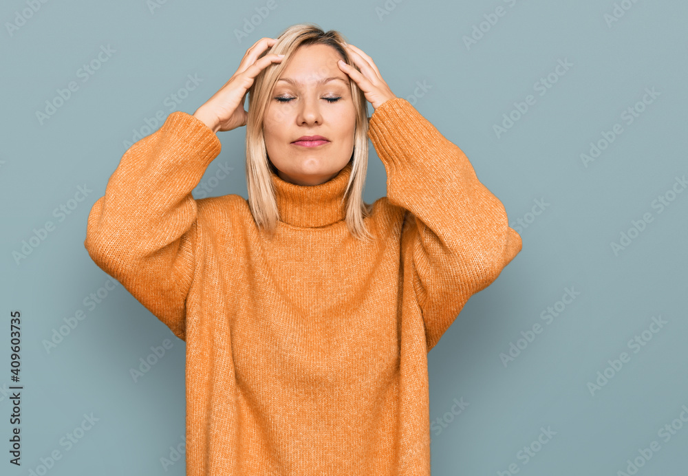 Middle age caucasian woman wearing casual winter sweater suffering from headache desperate and stressed because pain and migraine. hands on head. Middle age caucasian woman wearing casual winter sweater suffering from headache desperate and stressed because pain and migraine. hands on head.