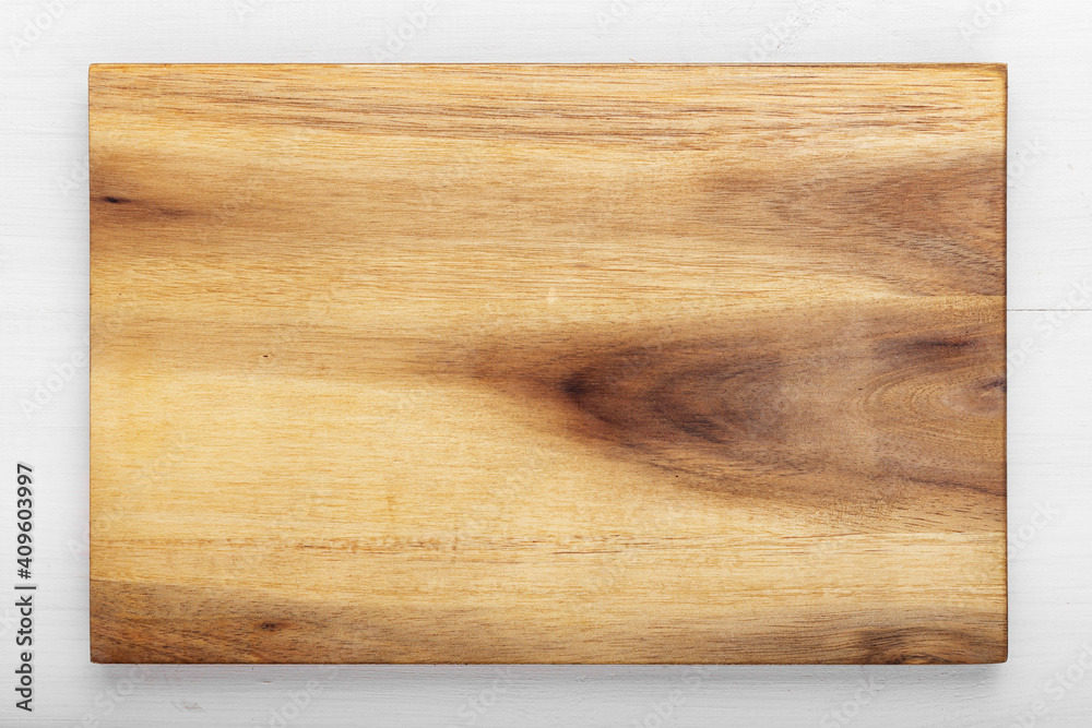 Cutting wooden board of rectangular shape on a wooden background. Space for text. Cutting wooden board of rectangular shape on a wooden background. Space for text.