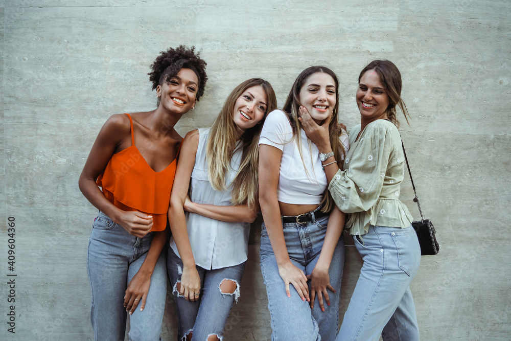 Portrait of young women only, smiling and watching the camera, standing against a wall, vintage filtered. - obrazy, fototapety, plakaty 