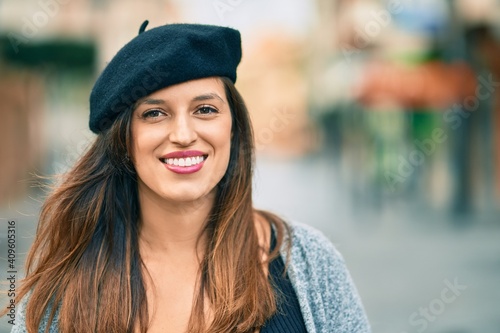 Young latin woman wearing french style standing at the city.