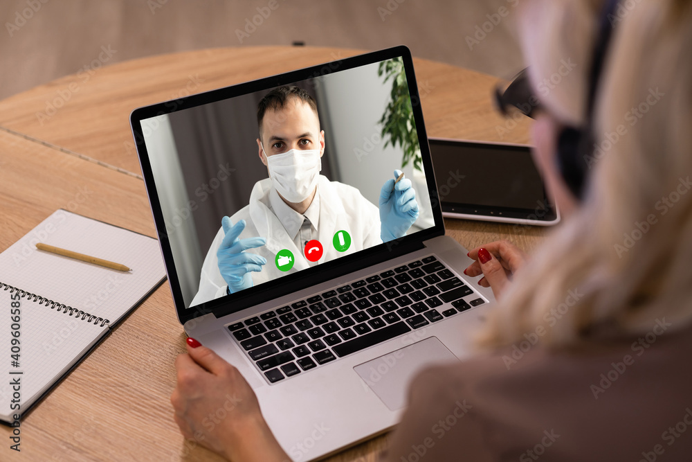 Doctor Having Video Conference On Laptop With Colleagues Doctor Having Video Conference On Laptop With Colleagues