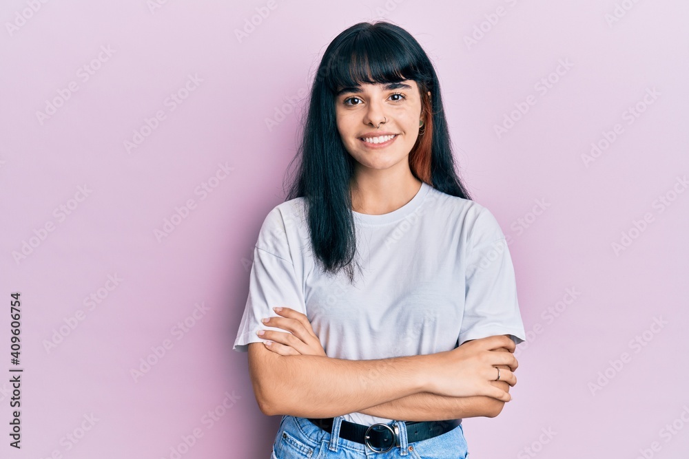 Young hispanic girl wearing casual clothes happy face smiling with crossed arms looking at the camera. positive person.