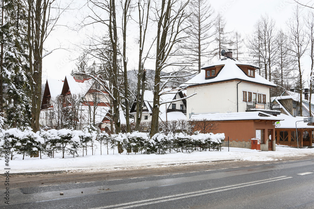 ZAKOPANE, POLAND - JANUARY 28, 2021: Streets and residential buildings in winter ZAKOPANE, POLAND - JANUARY 28, 2021: Streets and residential buildings in winter