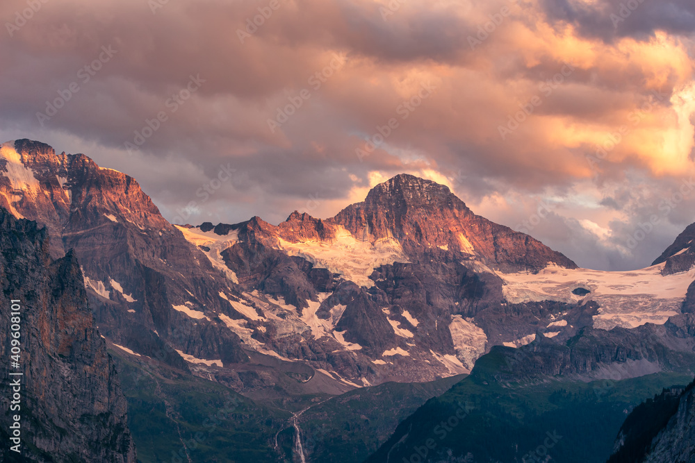 Lauterbrunnen Breithorn in warm golden evening light under a dramatic cloudy sky. Jungfrau region, Bernese Oberland, Switzerland