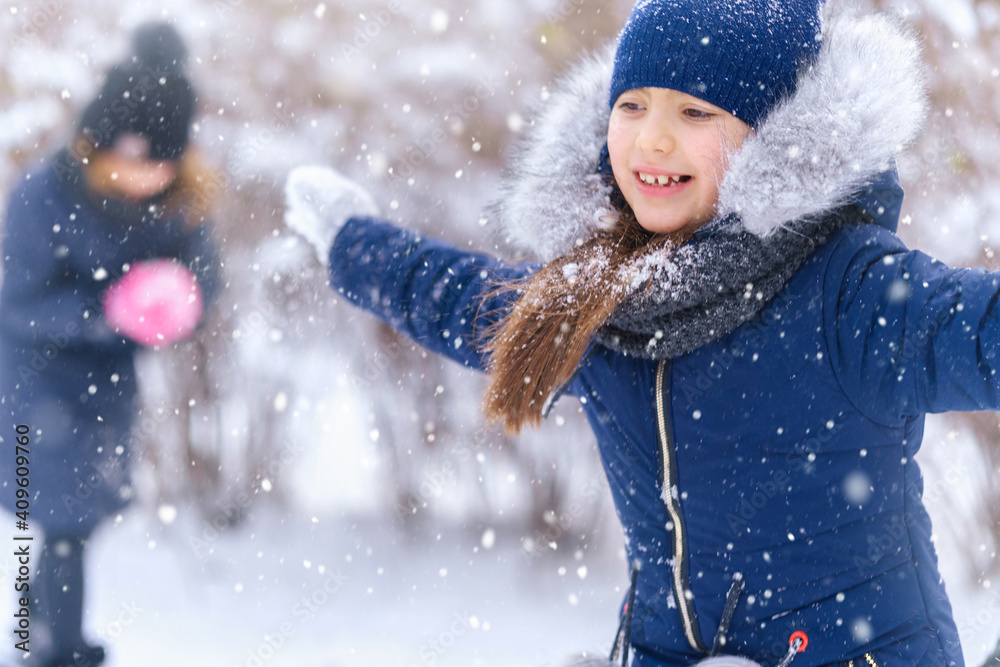 children playing with snow in winter outdoor, girls having fun on snowy winter and throwing snowballs children playing with snow in winter outdoor, girls having fun on snowy winter and throwing snowballs