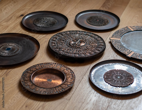 Mid century modern metal wall decor collection - wall plates and a mirror on wooden background