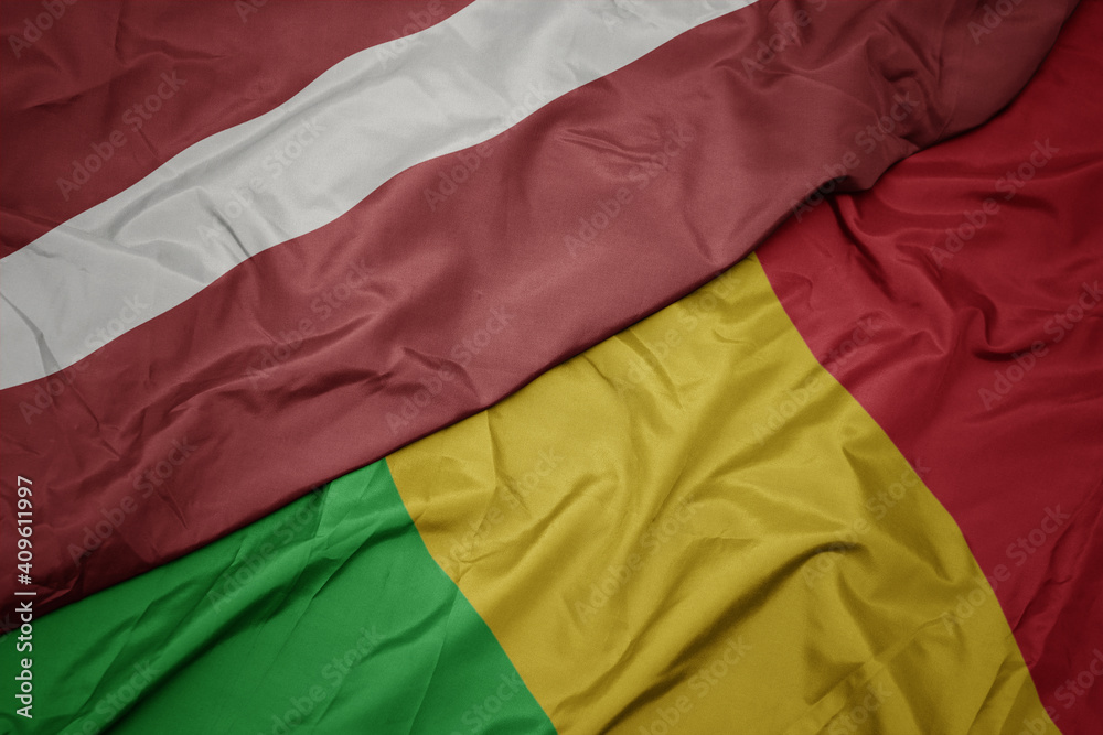 waving colorful flag of mali and national flag of latvia.