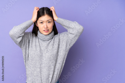 Young asian woman over isolated background doing nervous gesture