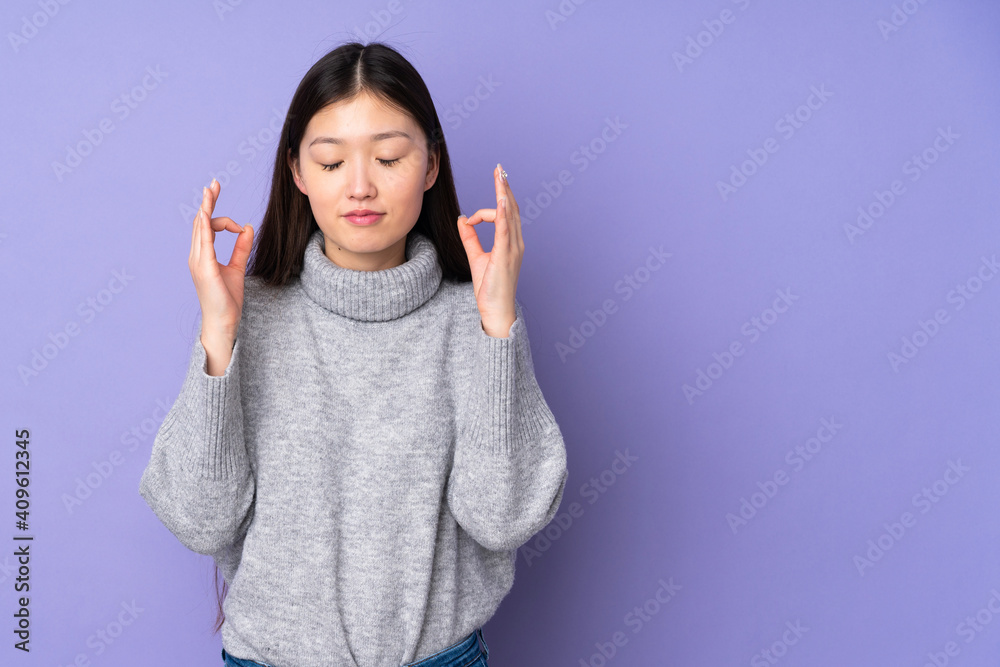 Young asian woman over isolated background in zen pose Young asian woman over isolated background in zen pose