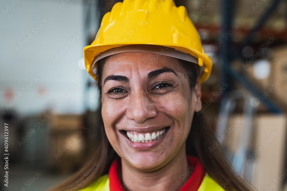 Portrait of happy Latin woman working in delivery warehouse - Logistic and industry concept