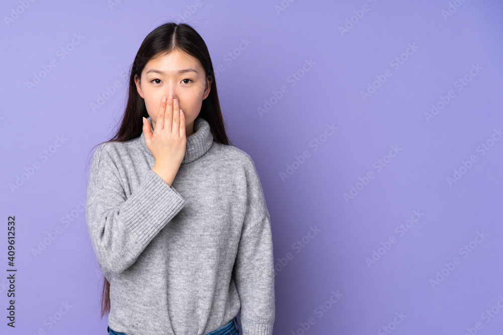 Young asian woman over isolated background covering mouth with hand Young asian woman over isolated background covering mouth with hand