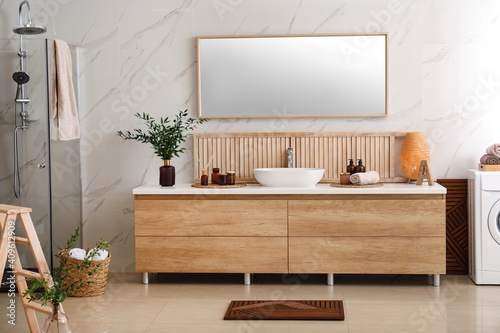 Modern bathroom interior with stylish mirror and vessel sink