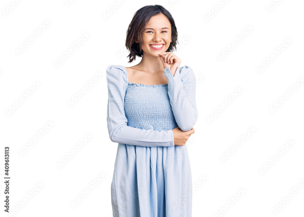 Young beautiful girl wearing casual clothes looking confident at the camera smiling with crossed arms and hand raised on chin. thinking positive. Young beautiful girl wearing casual clothes looking confident at the camera smiling with crossed arms and hand raised on chin. thinking positive.