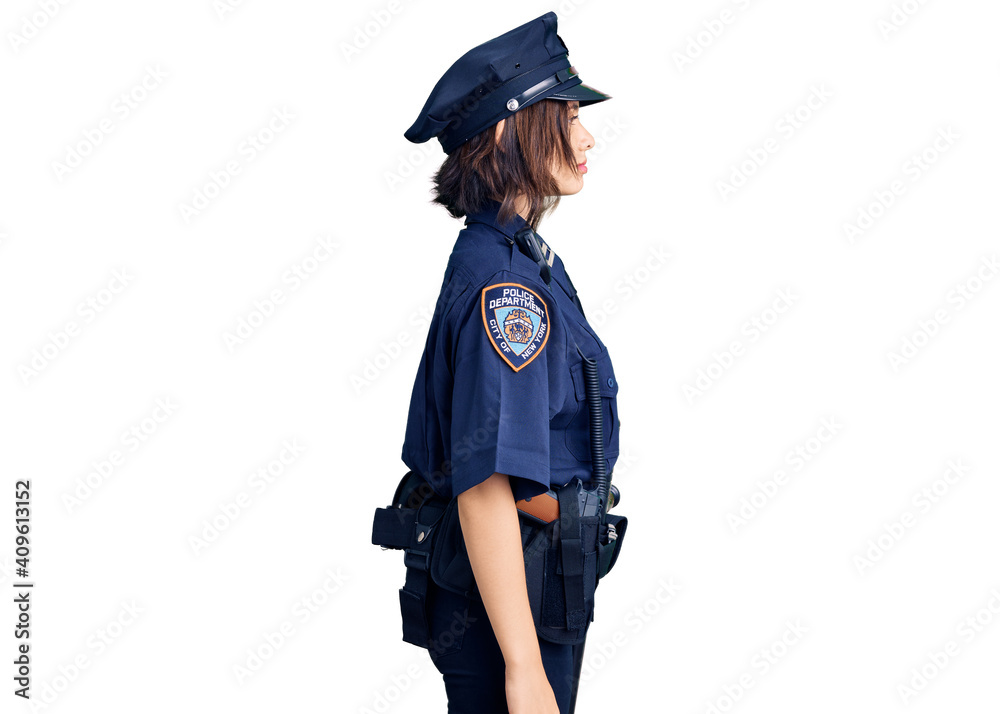 Young beautiful girl wearing police uniform looking to side, relax profile pose with natural face with confident smile. Young beautiful girl wearing police uniform looking to side, relax profile pose with natural face with confident smile.