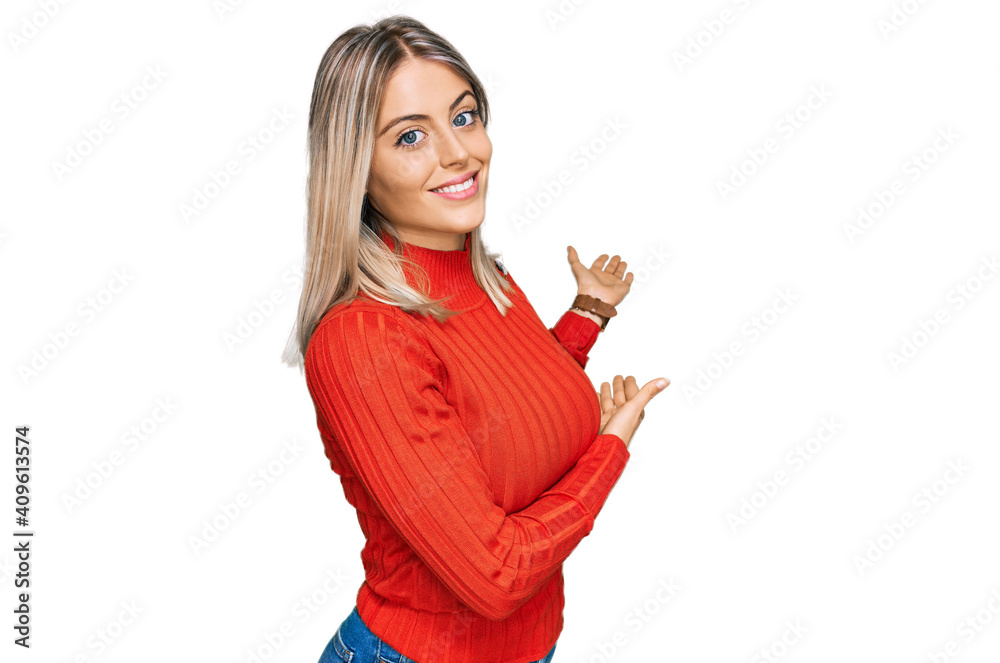 Beautiful blonde woman wearing casual clothes inviting to enter smiling natural with open hand Beautiful blonde woman wearing casual clothes inviting to enter smiling natural with open hand