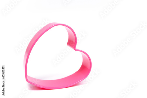 Plastic pink mold for making cookies in the shape of a heart