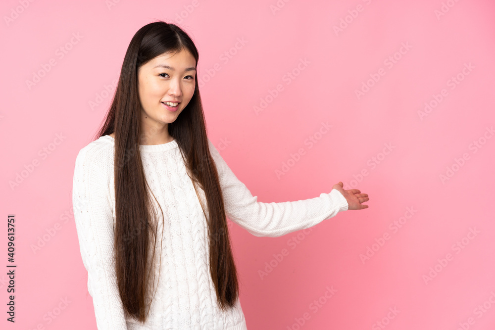 Young asian woman over isolated background extending hands to the side for inviting to come Young asian woman over isolated background extending hands to the side for inviting to come