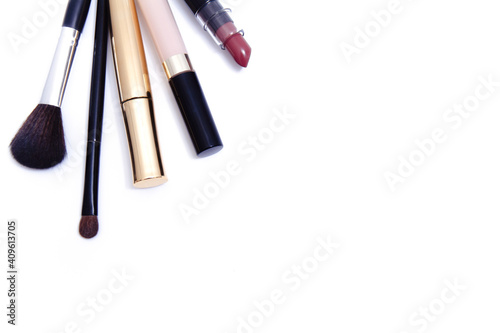 Mascara, consiler, lipstick and brushes for makeup on white background, top view