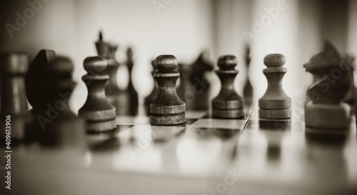 Wooden chess pieces on the chessboard.