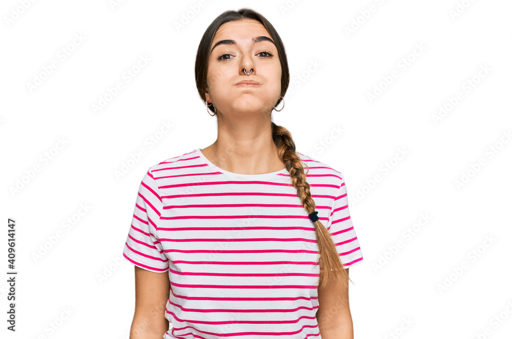 Young hispanic woman wearing casual clothes puffing cheeks with funny face. mouth inflated with air, crazy expression. Young hispanic woman wearing casual clothes puffing cheeks with funny face. mouth inflated with air, crazy expression.