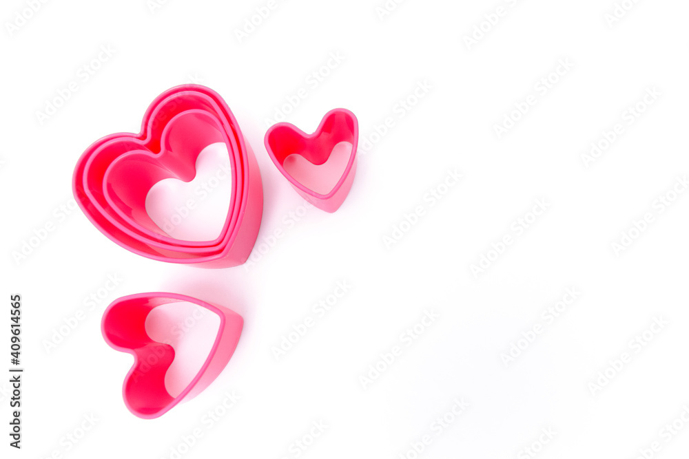 Plastic pink molds for making cookies in the shape of a hearts Plastic pink molds for making cookies in the shape of a hearts