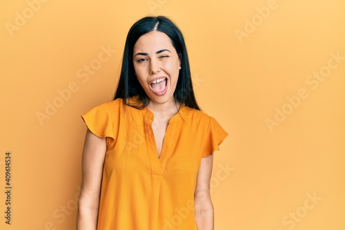 Beautiful young woman wearing casual clothes winking looking at the camera with sexy expression, cheerful and happy face. © Krakenimages.com